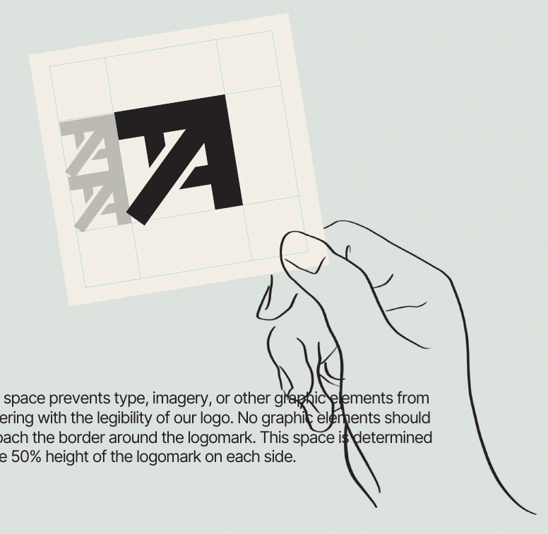 Original brand-guide drawing showing the logo clear-space grid on a card held in a hand