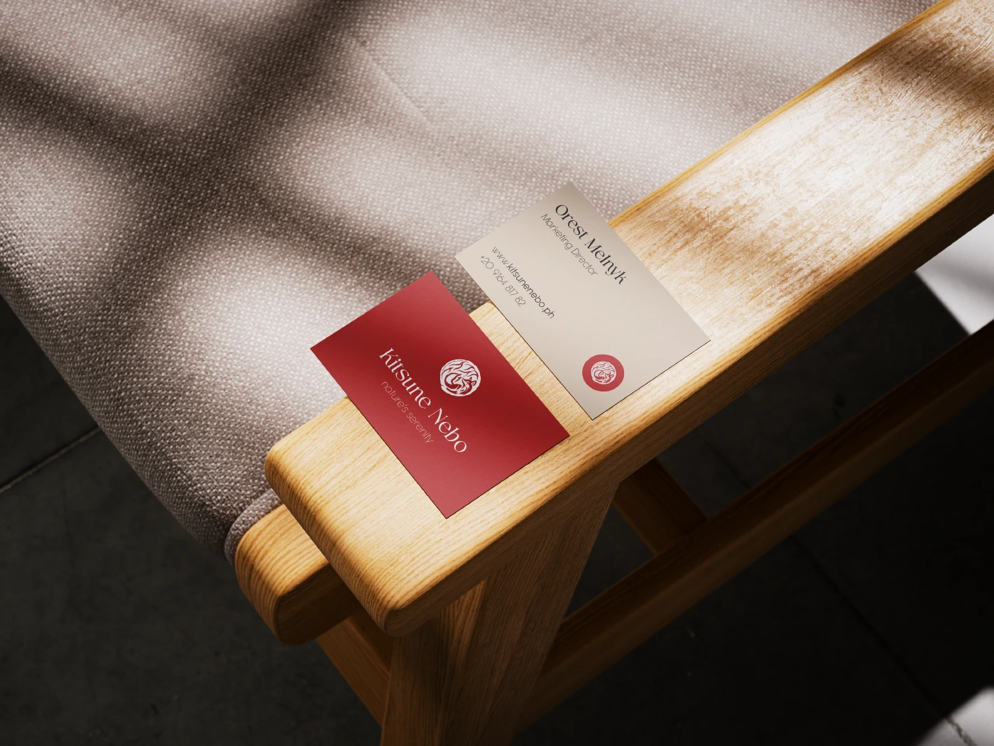 Original Kitsune Nebo business-card mockup on a wooden chair in soft daylight
